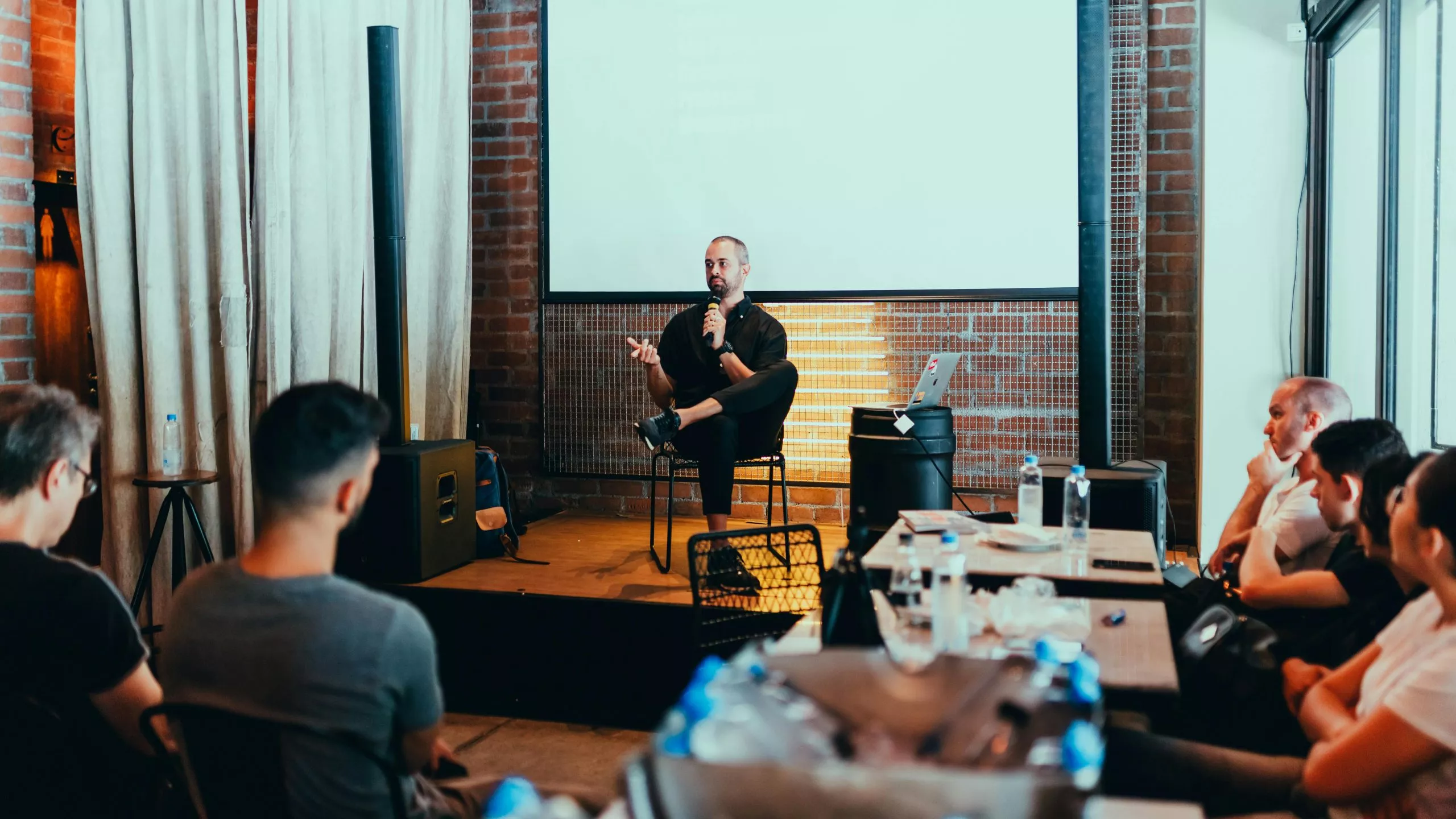 Man seated giving an impactful presentation