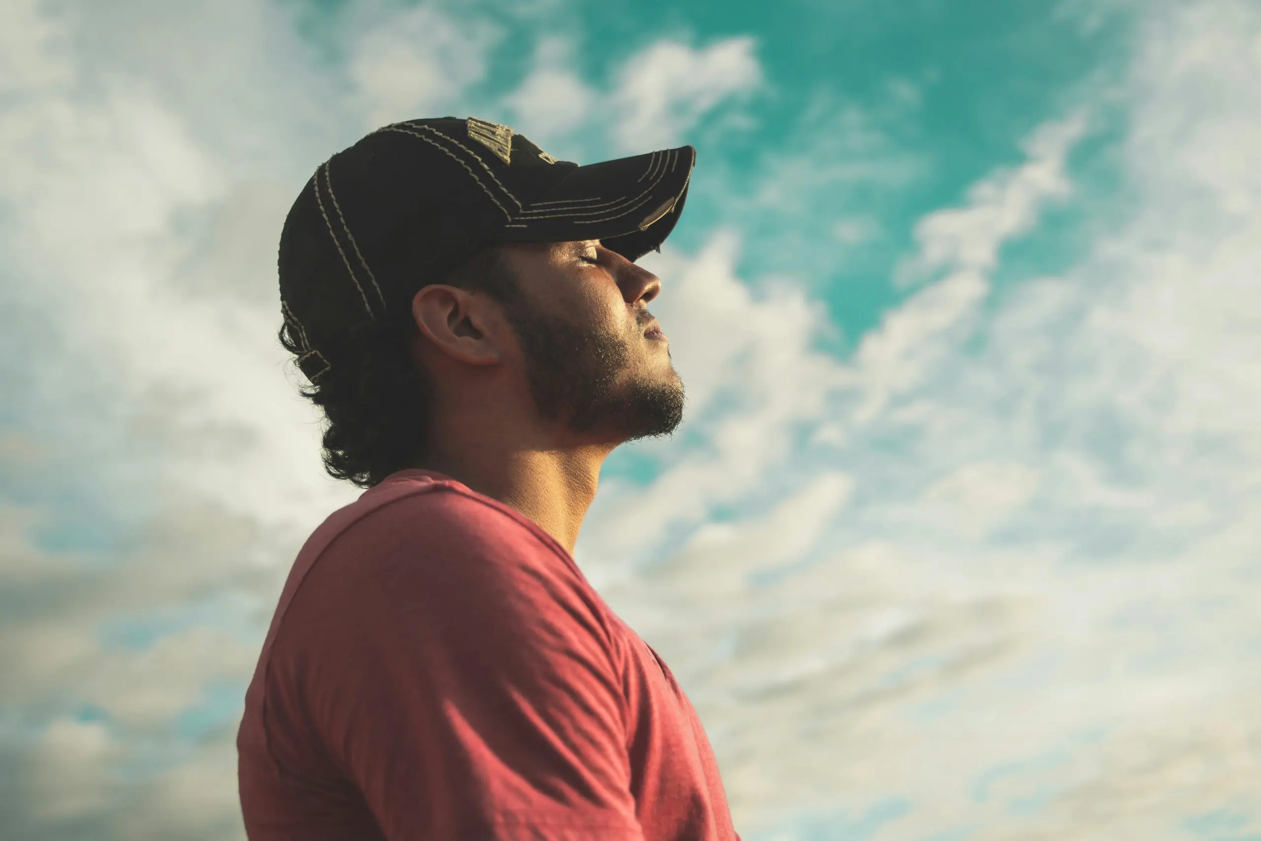 Person taking deep breaths under cloudy sky
